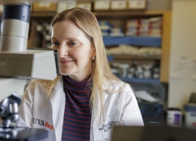 Dr. Kristin Anderson at the microscope Dr. Kristin Anderson at the microscope in her lab.