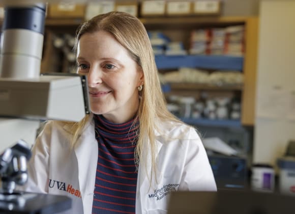 Dr. Kristin Anderson at the microscope in her lab.